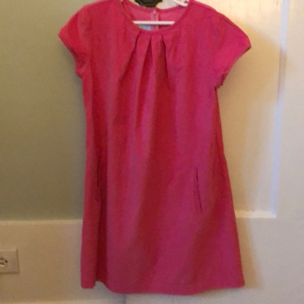 Pink corduroy dress with pockets.